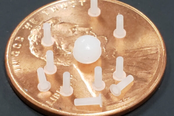 Micro Molding parts with resin on top of a penny
